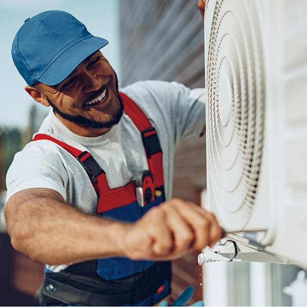 HVAC Repair Man working on AC Unit